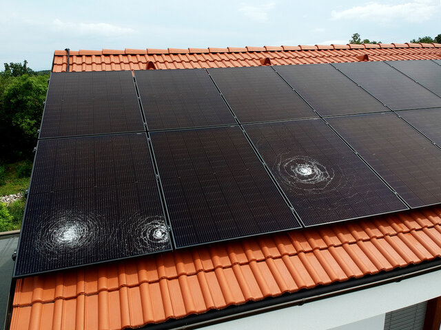 Three big dents from hail on solar panel